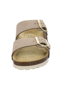 Brown suede two-strap sandals featuring adjustable metallic buckles, cork footbed, and textured rubber outsole with contrasting light sole.