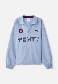 Light blue long-sleeve shirt featuring a folded collar, "FENTY" logo, and a round red patch with a logo, designed by Puma.