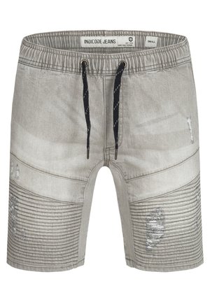 Grijze spijkershorts met elastische tailleband en zwarte trekkoord. Heeft geribbelde panelen en versleten accenten op de voorkant. Maat small.