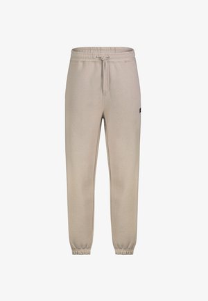 Beige jogger pants with elastic waist and ankle cuffs, drawstring closure, and a small logo patch on the side.