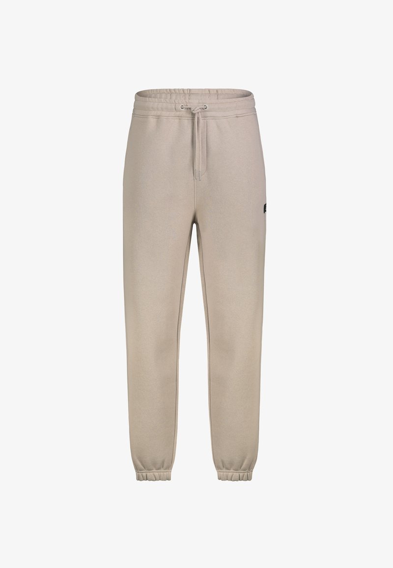 Beige Jogginghose mit elastischem Bund und Bündchen, Kordelzugverschluss und einem kleinen Logo-Patch an der Seite.