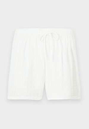 White cotton shorts with an elastic waistband and drawstring. Features a textured pattern with vertical stripes and side pockets.
