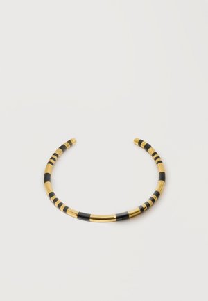 Open-ended gold choker necklace with alternating black and gold cylindrical segments on a white background.
