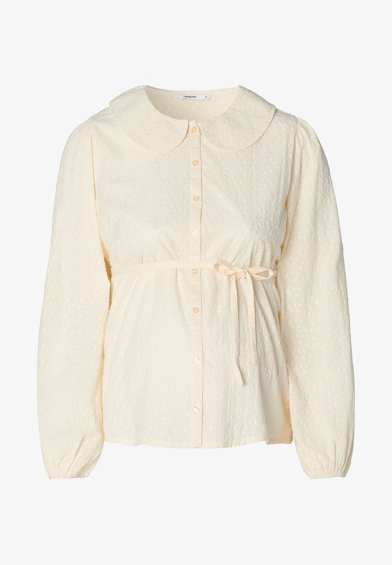 Cream blouse with a large rounded collar, textured fabric, button front, elasticized cuffs, and a waist tie for adjustable fit.