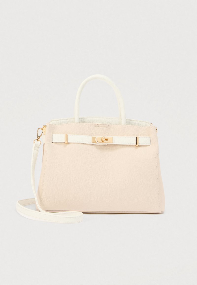 Sac à main beige clair avec une texture grainée, deux poignées supérieures, une bandoulière réglable, une sangle d'accent blanche et des finitions en métal doré.