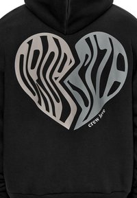 Black hoodie featuring a large heart graphic with layered, striped patterns in gray and beige. Text "crew love" displayed in white font.