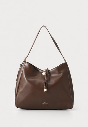Brown leather handbag with a single shoulder strap, rounded shape, gold hardware accents, and a braided pull detail on the zipper.