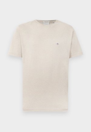 Light beige t-shirt made of soft fabric, featuring a crew neckline and short sleeves. Small embroidered logo on the chest.