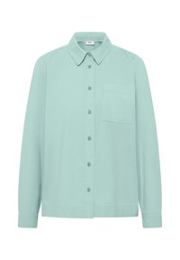 Chemise à manches longues vert clair avec col pointu et une poche poitrine, présentée sur un fond blanc.