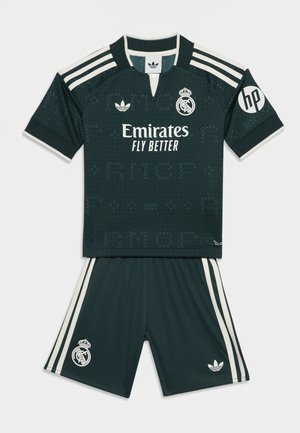 Maillot et short de football noir du Real Madrid avec des bandes blanches, logos Adidas et sponsors, et écusson du club sur le maillot et le short.