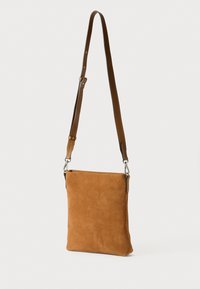 Brun semsket crossover veske med en flat rektangulær form, justerbar lærrem og detaljer i sølvmetall. Glatt tekstur, minimalistisk design.