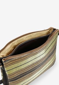 Borsa a tracolla a strisce marroni e gialle realizzata in materiale testurizzato, con chiusura a zip, tasca interna e foderatura liscia.