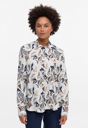 Langärmliges Hemd aus leichtem Stoff mit einem wirbelnden abstrakten Muster in Marineblau, Beige und Creme. Knopfverschluss vorne mit Kragen.