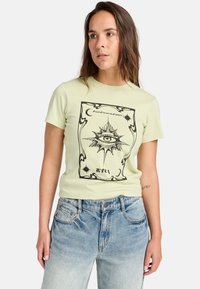 Light green short-sleeve t-shirt featuring a black illustrated eye design within a decorative border and the text "Past, Present, Future".