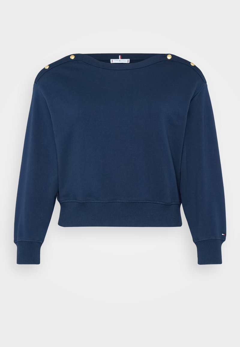 Marineblauwe cropped sweatshirt van katoen. Voorzien van gouden decoratieve knopen op de schouders en geribbelde boorden en onderrand.