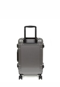 Compact gray hard-shell suitcase with two wheels, retractable black handle, and textured surface for durability; side compartments visible.