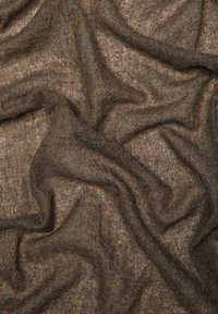 Brown, loosely woven fabric with soft, uneven folds and a slightly transparent texture.