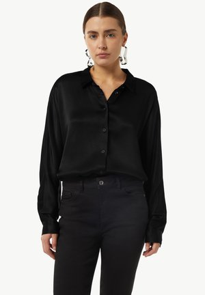 Black satin button-up shirt with long sleeves, collar, and subtle sheen, worn with black pants, displayed against a white background.