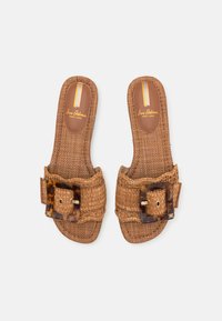 Sandales à enfiler en paille tissée marron, dotées d'une large bride avec une boucle écaille. Semelle intérieure souple avec un marquage discret en or.