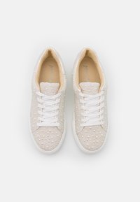 Sneakers bianche con tomaia in tessuto strutturato, decorata con piccoli dettagli perlati, dotate di lacci bianchi e di una soletta imbottita beige.