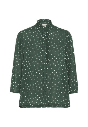 Zaļa blūze ar baltām punktiņām, ar frill apdari ap apkakli, pogas pa priekšu un trīs ceturtdaļu garuma piedurknēm.