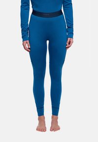 Leggings bleus avec une coupe ajustée, fabriqués dans un matériau lisse. Dotés d'une taille noire et de poches latérales zippées.
