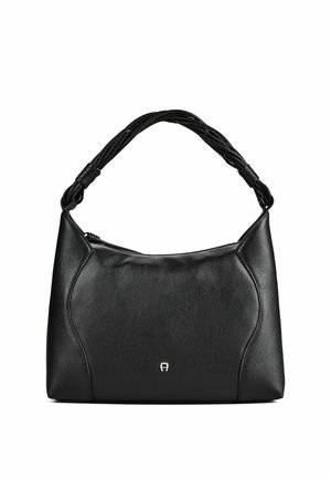Sac à main en cuir noir avec coutures courbes, poignée tressée et petit logo argenté à l'avant, présenté sur fond blanc.