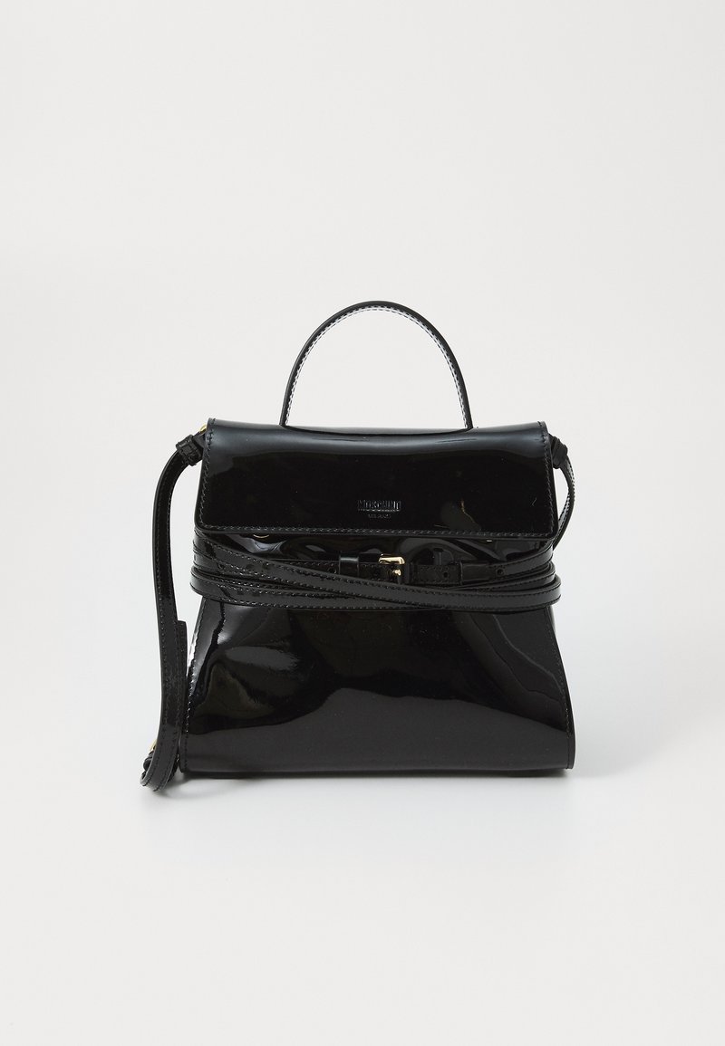 Black glossy leather handbag with top handle, long adjustable strap wrapped around, and front flap closure against plain background.