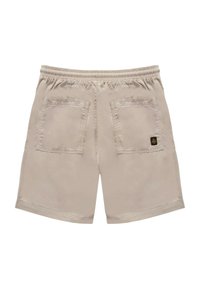Shorts beige chiari con vita elastica, due tasche posteriori e dettagli di cucitura ben visibili. Tessuto resistente con una texture liscia.