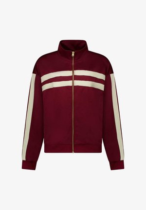 Bordeauxrode jas met ritssluiting, voorzien van twee horizontale witte strepen over de borst en witte verticale strepen langs de mouwen.