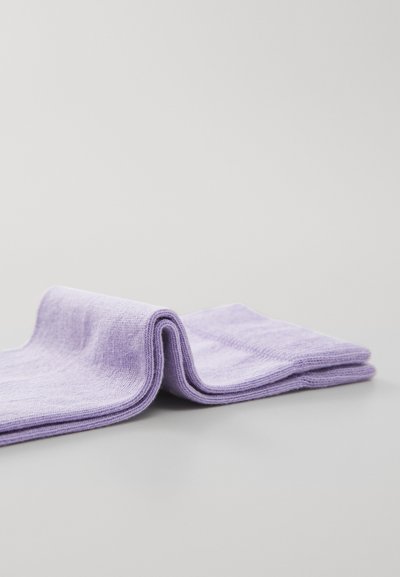 Purple cotton socks displayed folded, featuring a soft texture, smooth fabric, and visible seams along edges.