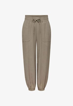 Pantalon beige coupe décontractée avec taille élastique, cordon, poches plaquées devant et poignets élastiques aux chevilles.