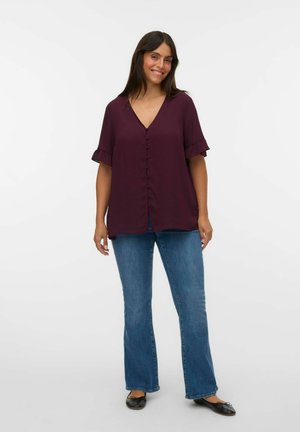 Burgundy blouse with a V-neck, short ruffled sleeves, and front button closure, paired with blue flared jeans and black flats.