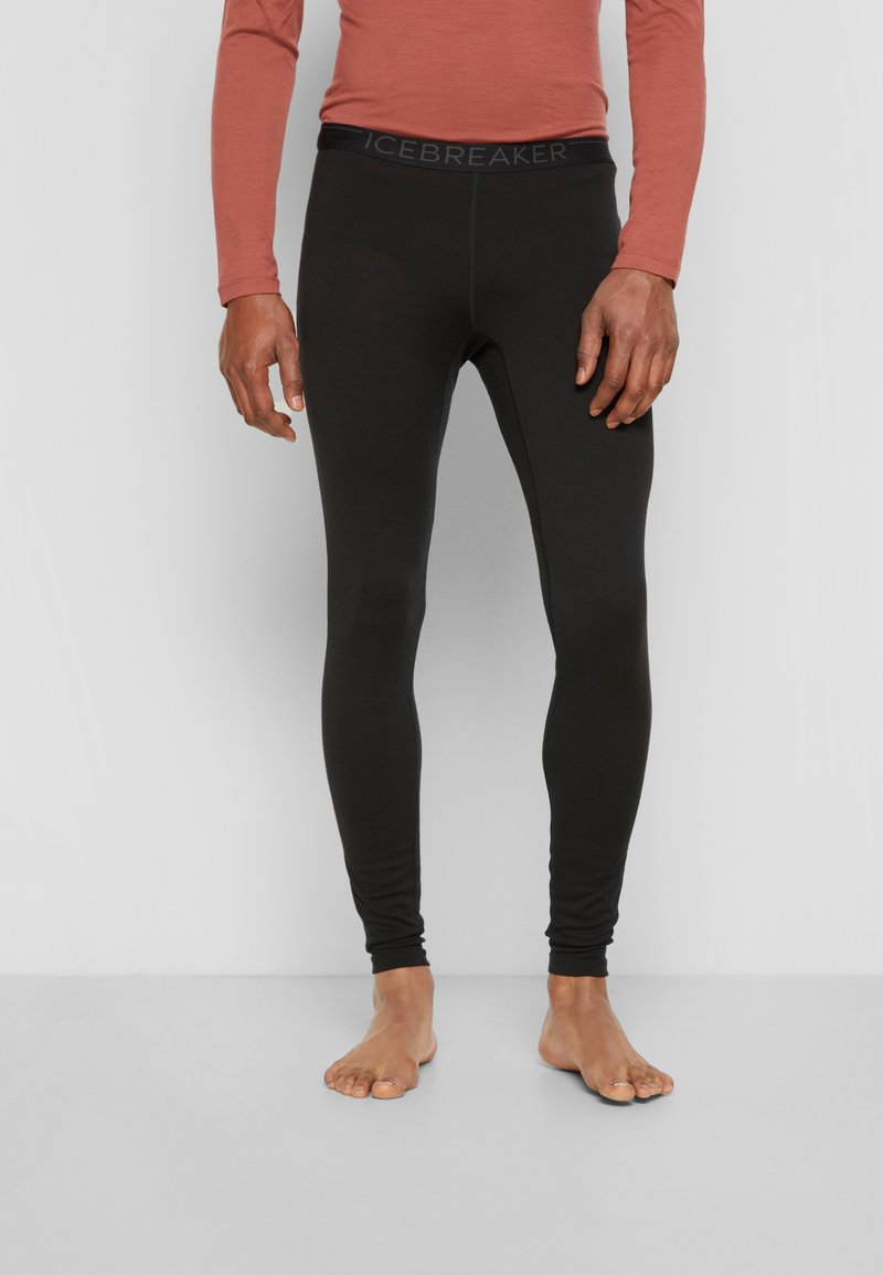 Black leggings made of stretchy fabric with a slim fit, featuring a wide waistband labeled "ICEBREAKER" in a subtle font.