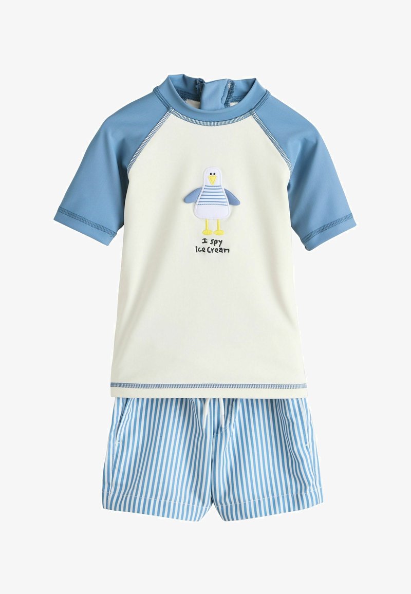 Ensemble de maillot de bain pour enfants avec manches courtes bleu clair, corps crème orné d'une mouette et du texte "Je guette la glace", et short rayé bleu et blanc.