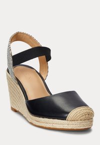 Svart lädersandaler med kilklack som har en vävd juteplattform, rund tå med repdetaljering och en kontrasterande tygrem vid ankeln.