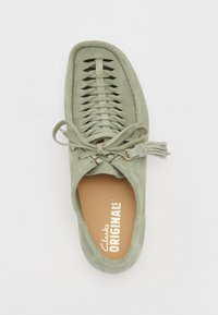 Zelené semišové topánky na skĺznutie s tkaným čipkovaním, okrúhlym prstom a mäkkou koženou stielkou s brandingom "Clarks Originals".