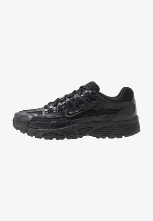 Black athletic shoe featuring a mesh and synthetic upper, textured surface, lace-up design, and a patterned rubber sole for traction.
