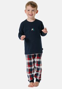 Marineblaue Langarmbluse mit einem kleinen Baum-Graphic, kombiniert mit rot, grün und weißen karierter Schlafanzughose. Weicher Stoff, lockere Passform.