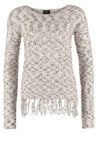 Pull en maille beige clair avec des taches foncées, présentant un large col et un détail de franges à l'ourlet. Manches longues, matière texturée.
