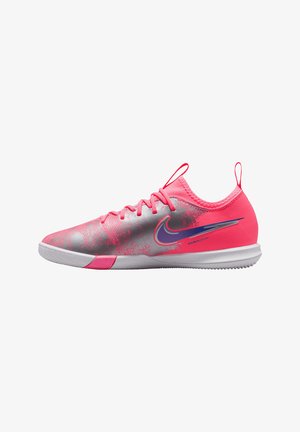 Low-profile indoor soccer shoe with pink and silver upper, purple Nike swoosh, lace closure, and white sole.
