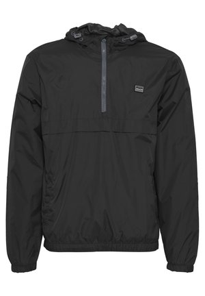 Black lightweight windbreaker jacket with a hood, elastic cuffs, and waistband. Features a half-zip front and logo on the chest. Waterproof material.