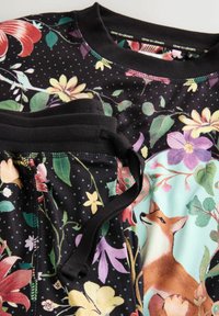 Dark floral patterned sleepwear set with a fox and flowers design, featuring a drawstring waist and ribbed neckline.
