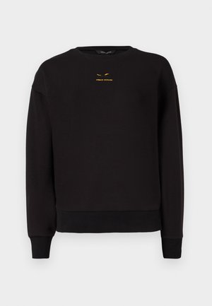 Svart hettegenser laget av myk stoff med rund hals, ribbede mansjetter og kant. Merkbar gul brodering av "A|REMAN EXCHANGE" på forsiden.