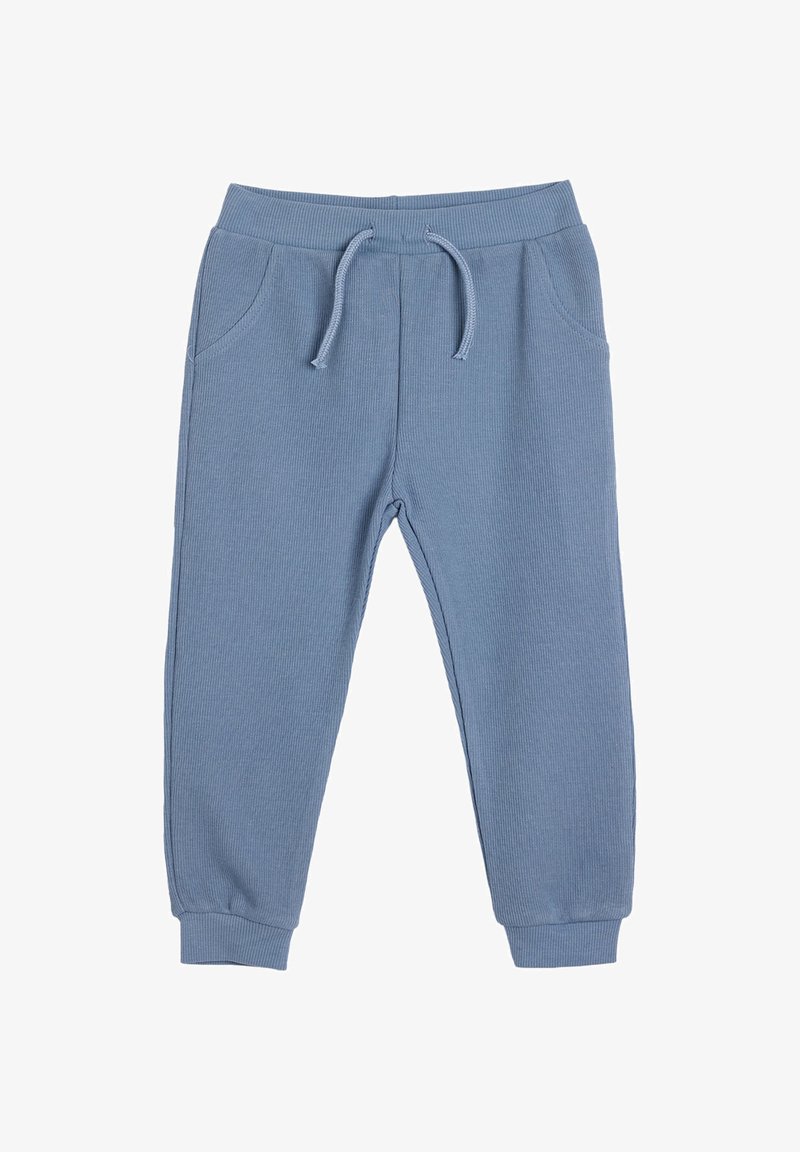 Blaue gerippte Jogginghosen mit einem elastischen Bund, verstellbarem Kordelzug und zwei seitlichen Taschen. Mit enganliegenden Bündchen an den Knöcheln abgeschlossen.