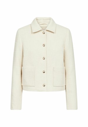 Kermanvärinen, teksturoitu nepparillinen takki, jossa kaulus ja kaksi etutaskua, suunniteltu istuvaksi leikkaukseksi.