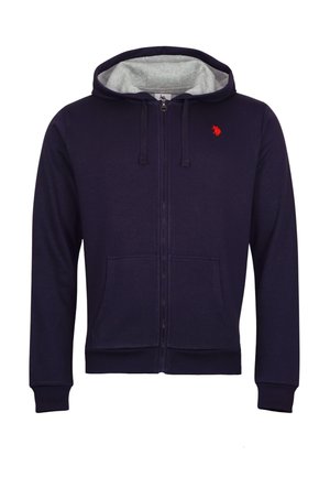 Hoodie zippé bleu marine avec intérieur gris, cordons de serrage, poches frontales et un petit logo rouge sur la poitrine. Fabriqué en matériau doux.