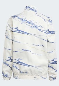 Vit jacka med blå marmor mönster, featuring en ståkrage, elastiska ärmslut och en smal midja för en avslappnad passform.