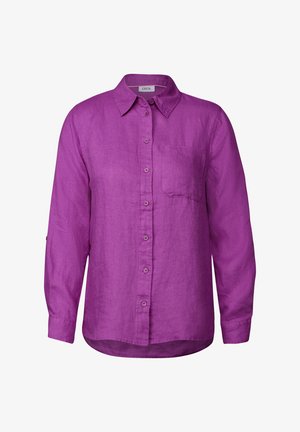 Camicia lunga in lino viola con colletto, chiusura frontale a bottoni, taschino singolo sul petto e opzione di maniche arrotolate per una vestibilità regolabile.