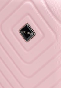 Pink hard-shell suitcase featuring a textured surface with diagonal grooves and a black logo panel displaying "WITTCHEN." Square metal accents.